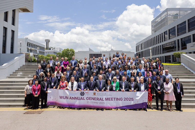 large group shot with banner that reads Worldwide Universities Network