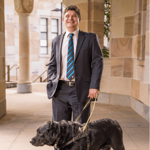 Paul Harpur with Guide Dog in UQ St Lucia Great Court