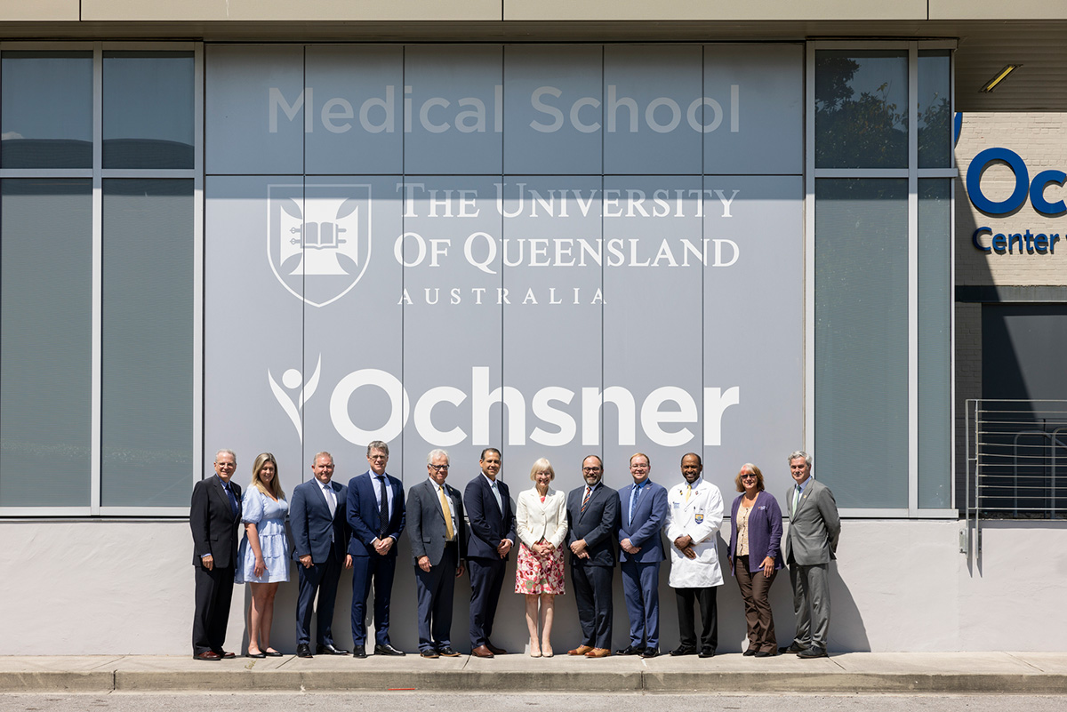 Delegation standing in group outside the UQ-Ochsner building 