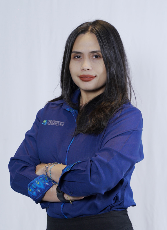 Syanthy standing with folded arms looking directly at the camera wearing her work shirt