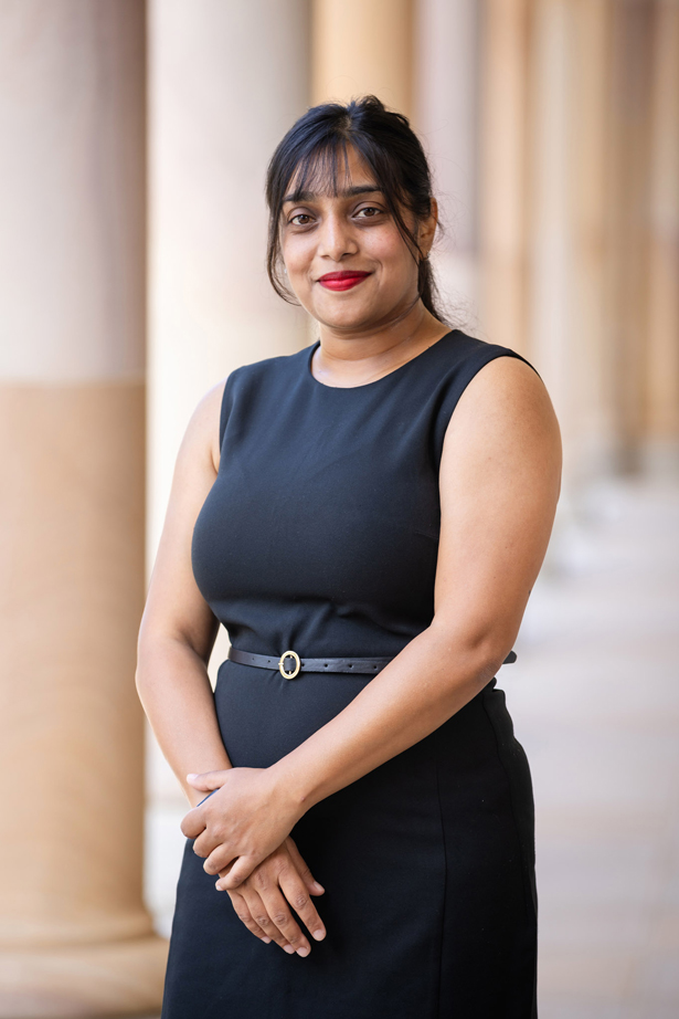 Krishtee Devi headshot at UQ St Lucia in front of sandstone pillars