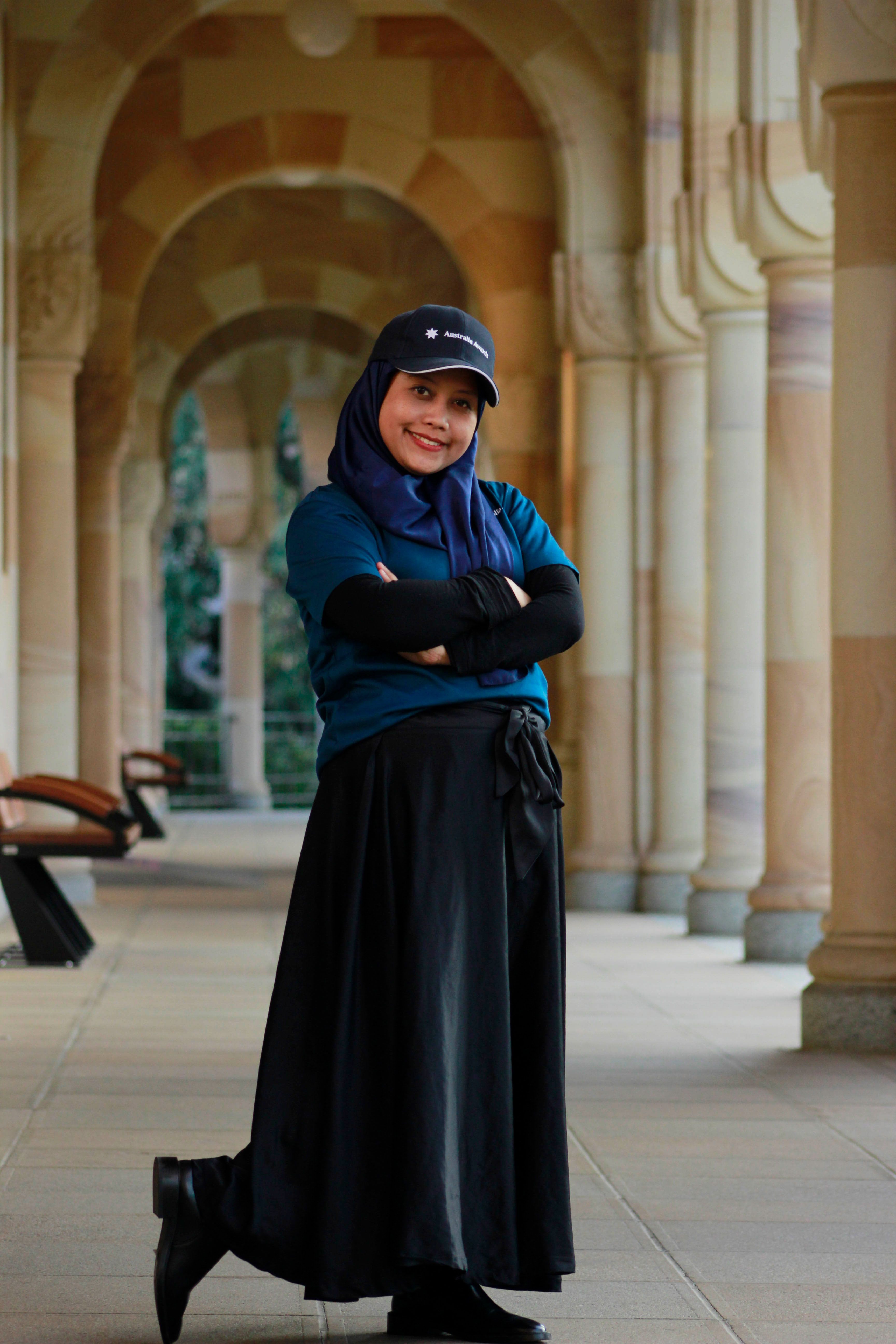 Desi Utami standing in St Lucia's Great Court during her UQ PhD studies. 