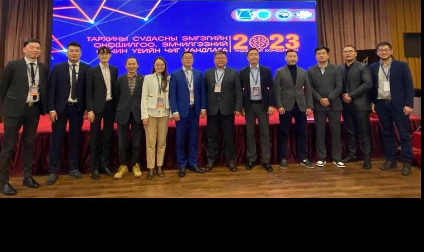 Dr  Ambaselmaa Bayarsaikhan (fifth from left), the only woman in a group of 11 specialist doctors, at a conference in 2023 on the topic of "Cerebral Vessel Disorder Diagnosis and Treatment". 