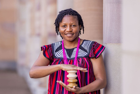 Johanna is holding bobbin insulators, which are made from clay, feldspar and quartz. These insulators are used to connect houses to electricity and were produced by SMEs in Dedza, Malawi. 