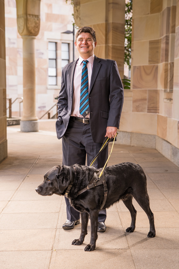 Paul Harpur with Guide Dog in UQ St Lucia Great Court
