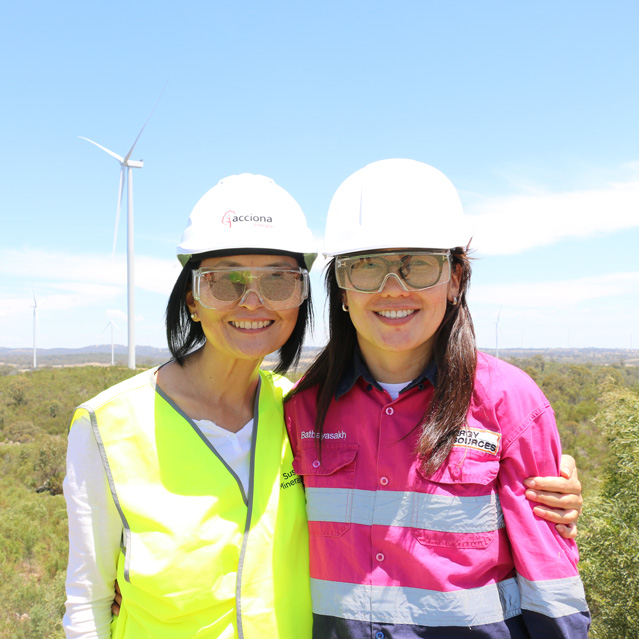 Professor Dr Enkhzaya Chuluunbaatar and Batbayasakh Ayurzana wear hard hats to their visit to a wind farm.