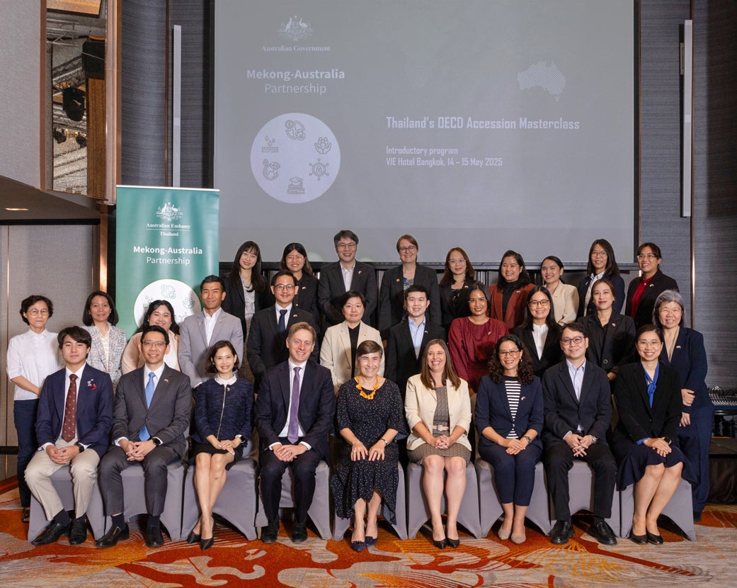 Group photograph in Thailand - of Mekong-Australia Partnerships banner behind them