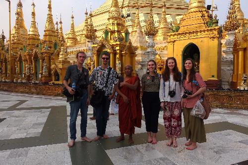 Students in Myanmar in front of buildings