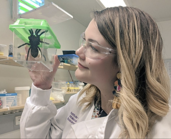 Samantha holding a whistling tarantula in a safe box