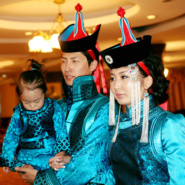 Saka with his wife, Agiimaa Bold, and son, Denzentseren Saruultur, in traditional dress at their wedding.