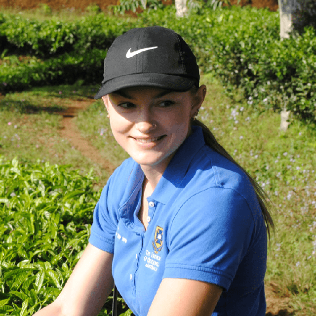 Jessie Harper using shears on produce on the land