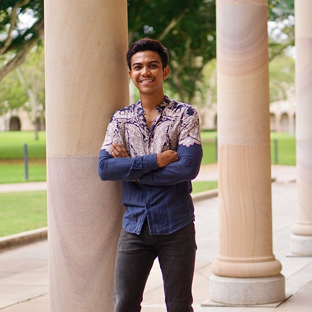 Muhammad leaning against Great Court's sandstone pillar