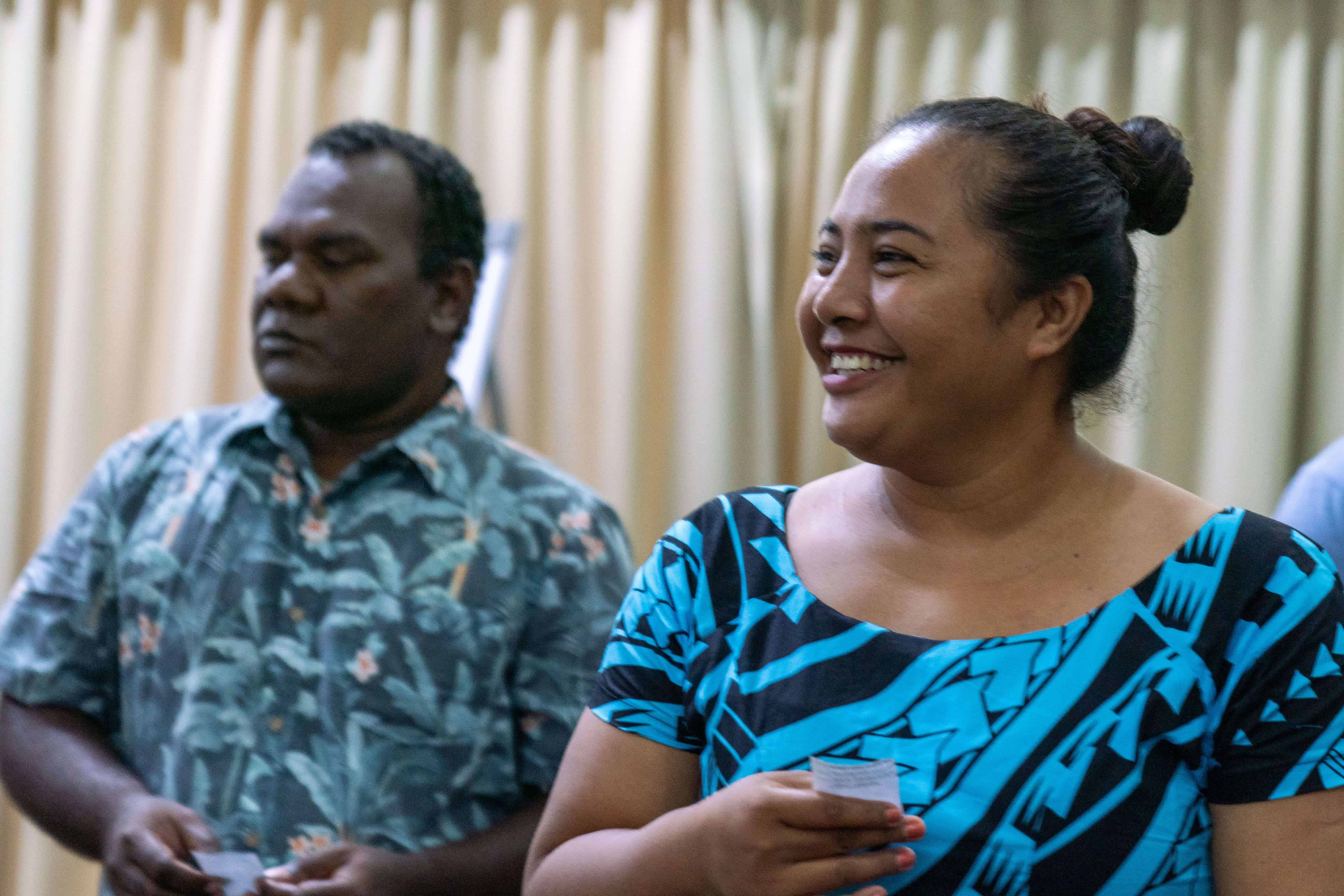 Two Pacific Island peoples smiling