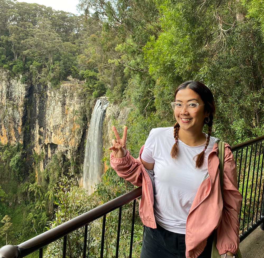 Sumayyah Abdurrahman standing in front Springbrook National Park waterfall