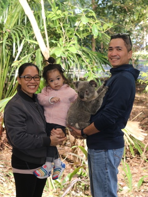 Miriam Agnes Yu and family holding a koala