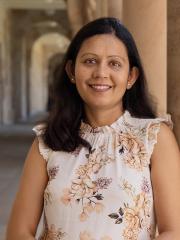 Nitika leaning against sandstone in UQ Great Court