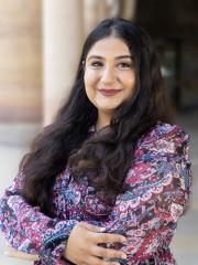 Prachi Rehan in the Great Court standing with the sandstone columns behind her