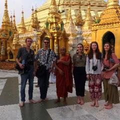Students in Myanmar in front of buildings