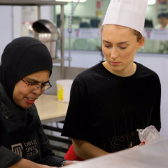 Students learning traditional Malaysian cooking skills in the commercial kitchens at Taylors University, Kuala Lumpur