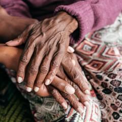 older woman's hands over a younger woman's