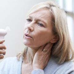 Women in her early 60s fanning herself - grey hair, attractive