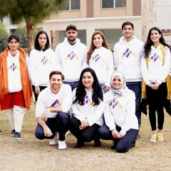 Metric founders wearing their the same white jumper with finance logo - upturned triangle with equal sign built into the point