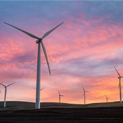 Wind turbine at sunset on a hill 
