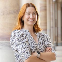 Eliana Burbano Mora in the Great Court in front of sandstone pillars