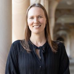 Zoee in front of sandstone pillars in Great Court, UQ
