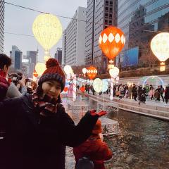 Jennifer in South Korea with lanterns over water