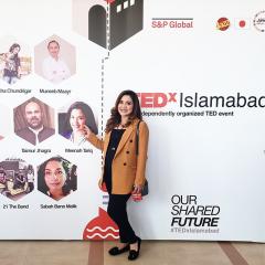 Meenah in front of TEDx Islamabad media wall 