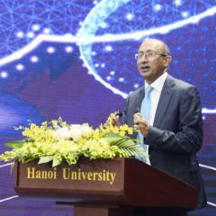 Chancellor of The University of Queensland (UQ), Mr Peter Varghese AO making a speech at podium in font of blue background