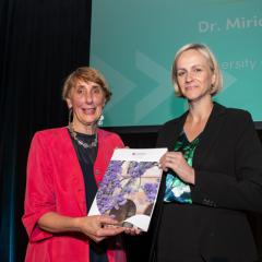 Jenny dixon standing next to Dr Miriam Moeller receiving award