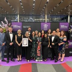 Group photo at the Qld Premier's Awards of UQ International Development in black tie dress (formal)