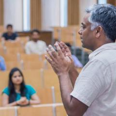 Man speaking in front of lecture audience